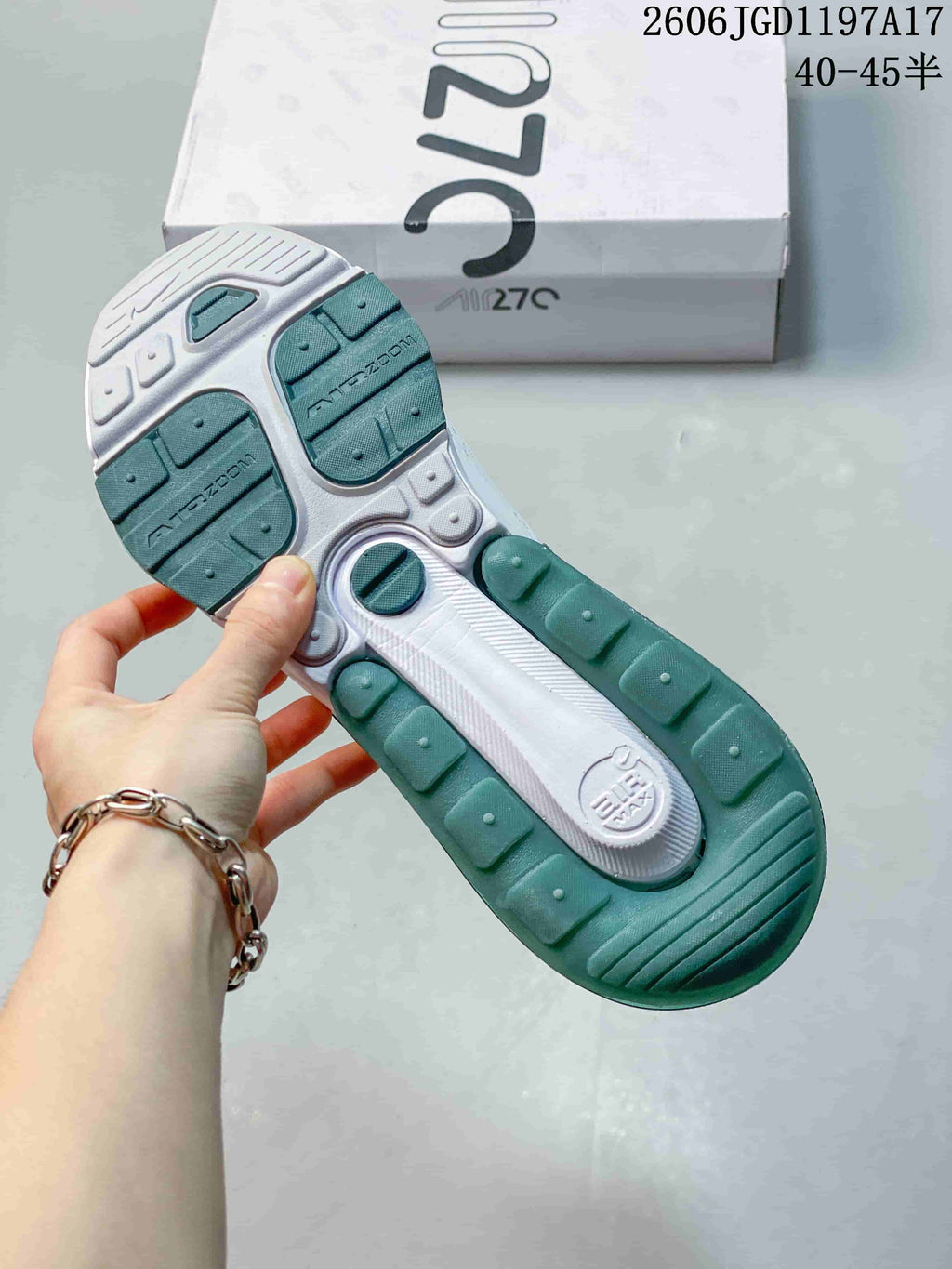 Underside of the Nike Air Max Pulse sneaker showing the green and white outsole.
