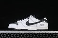 Side view of a white and black Nike SB Dunk Low sneaker