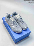 Pair of grey Song for the Mute x adidas Adizero PR SFTM sneakers on a blue box