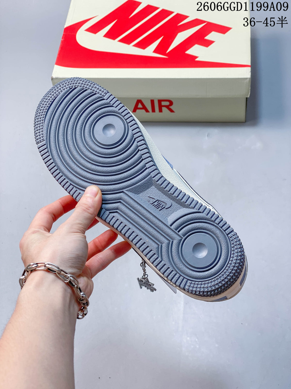Close-up of the gray outsole tread on a blue and off-white low-top sneaker.