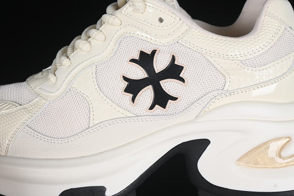 Close-up of mesh-look side panels, emblem, and sculpted sole