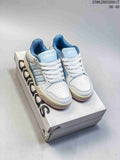 Pair of white and light blue adidas Entrap sneakers on a shoebox.