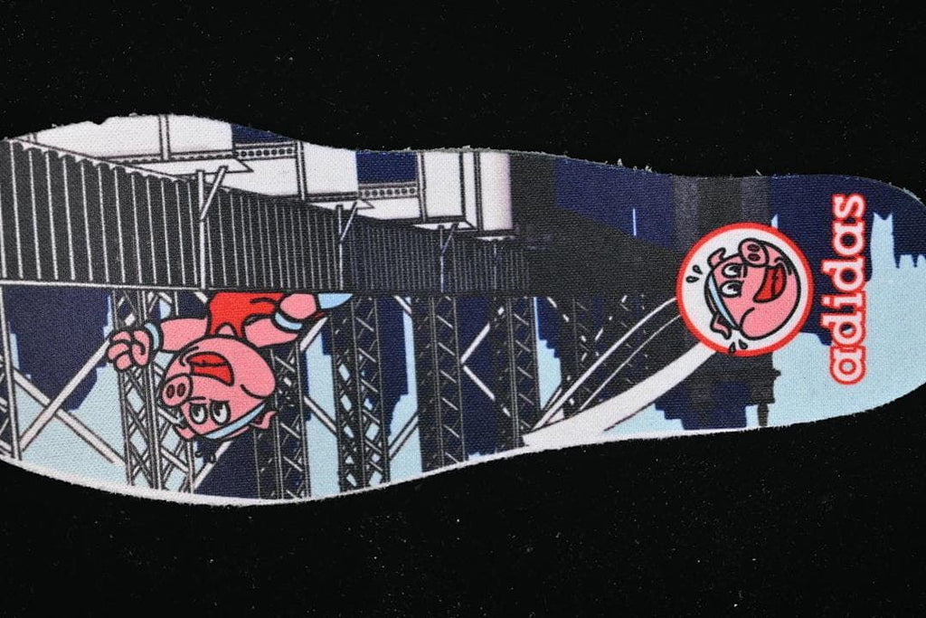 Printed insole featuring illustrated characters and adidas branding.