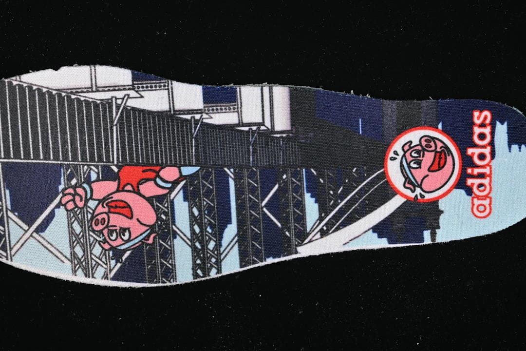 Printed insole featuring illustrated characters and adidas branding.
