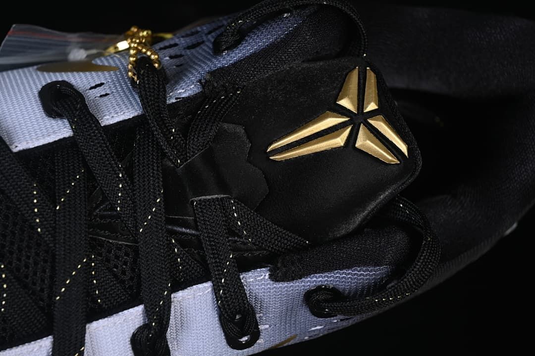 Close-up of black laces and gold Kobe logo on the tongue