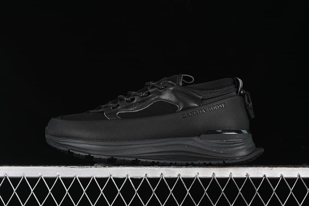 Black Canada Goose trail-style sneaker shown in side profile