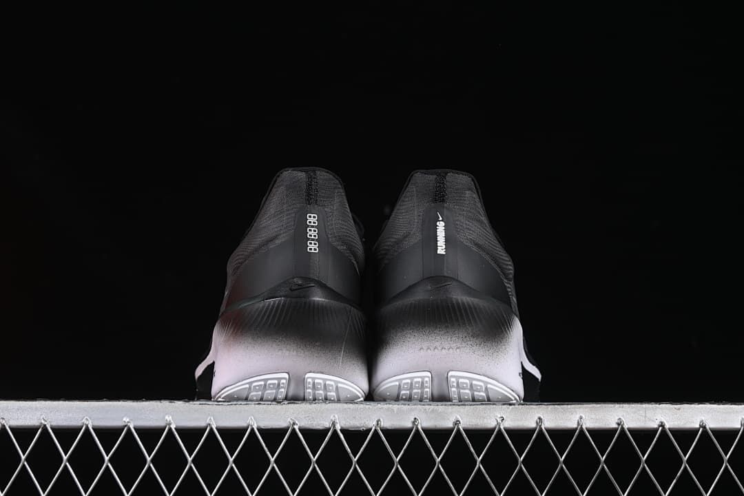Rear view of the pair showing heel details and patterned outsole sections