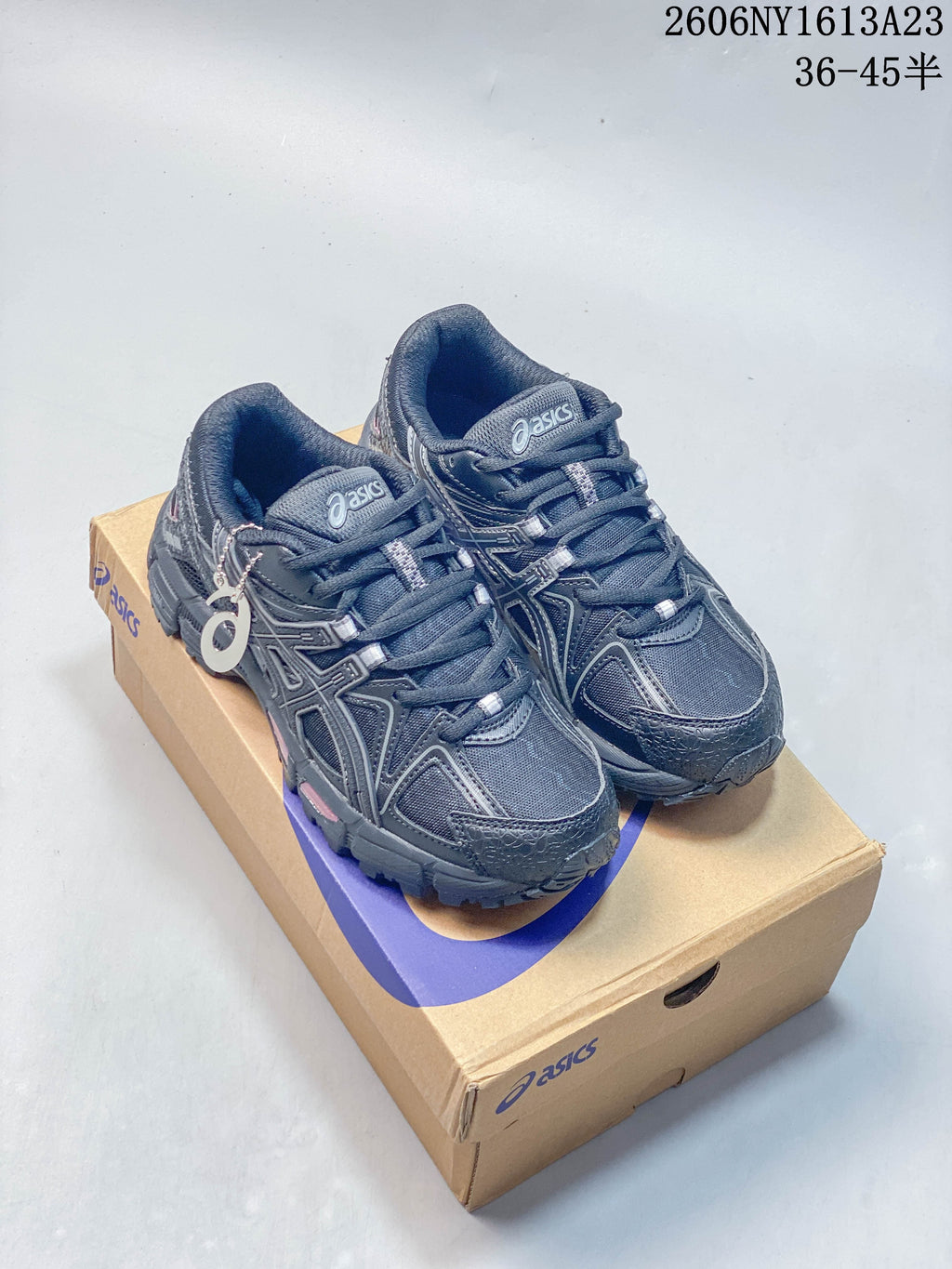 Pair of charcoal ASICS Gel-Kahana 8 FL sneakers on a shoebox
