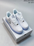 White textured low-top sneakers with pale blue outsoles, shown on a box; cream-and-brown sneakers are also visible.