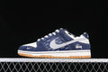 Side view of navy and grey low-top Dunk sneakers with script graphics and a gum-colored outsole