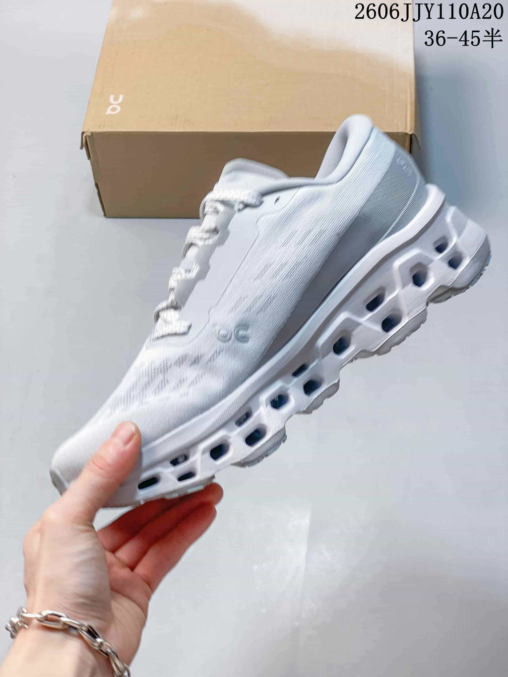 Side profile of the white and gray shoe with a chunky segmented outsole; image states sizes 36–45.5.