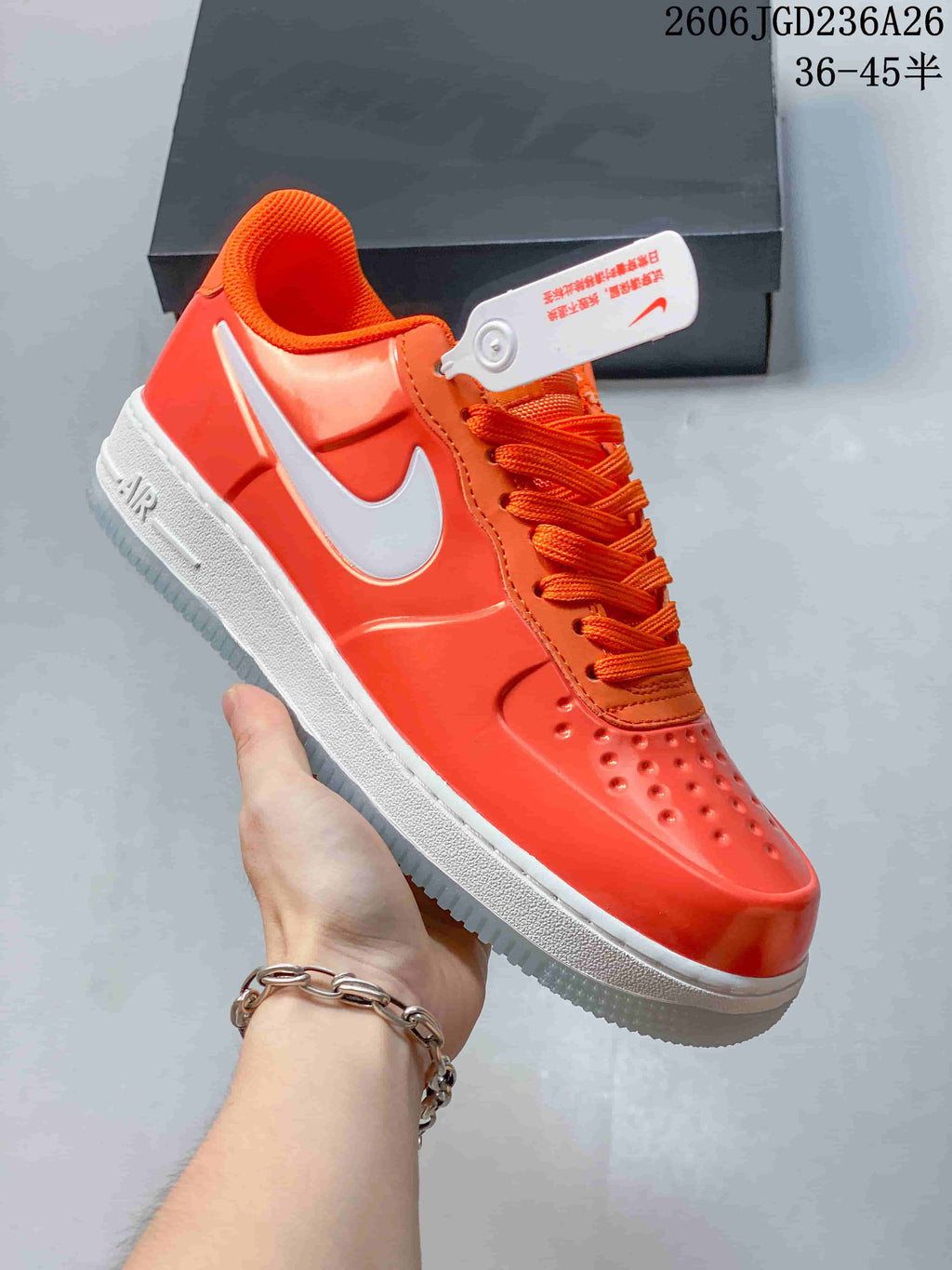 Side view of an orange Nike Air Force 1 '07 Low sneaker with white Swoosh and midsole