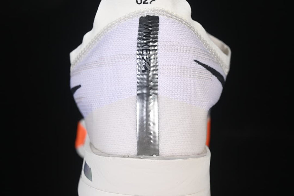 Rear view showing the heel, reflective center strip, and small side logos.