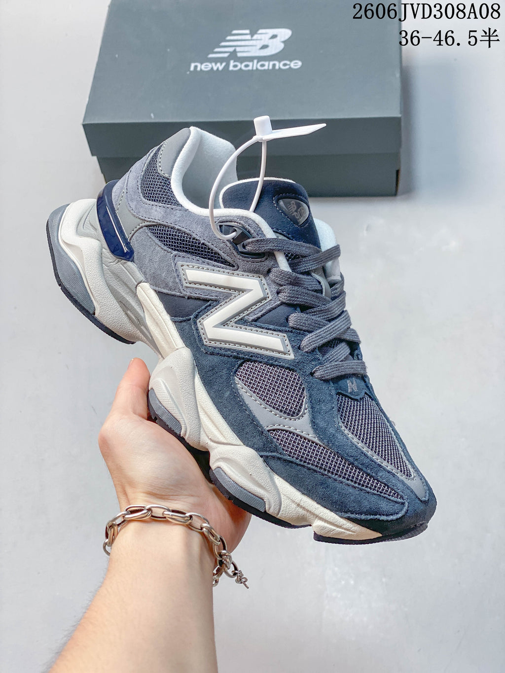 Angled side view of a blue-grey New Balance 9060 sneaker
