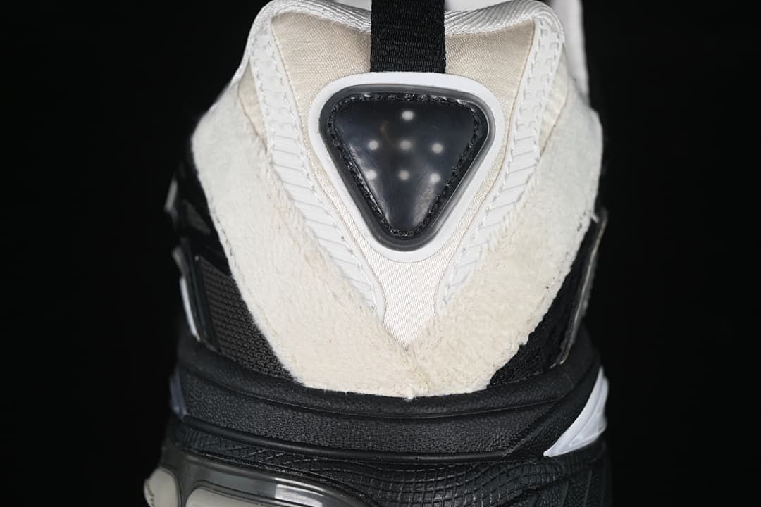 Rear close-up of the sneaker showing its off-white heel panels, pull tab and sculpted sole.