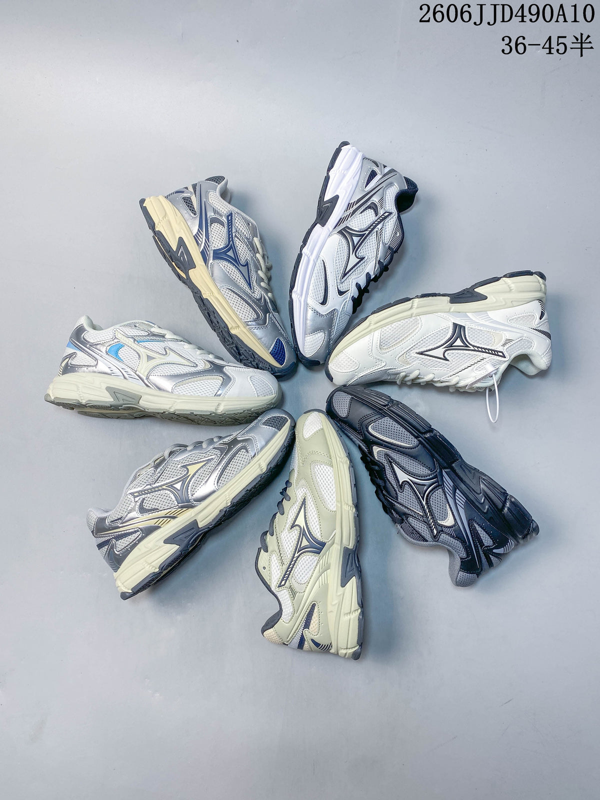 White mesh Mizuno sneaker with dark outlined logo and cream-colored sole.