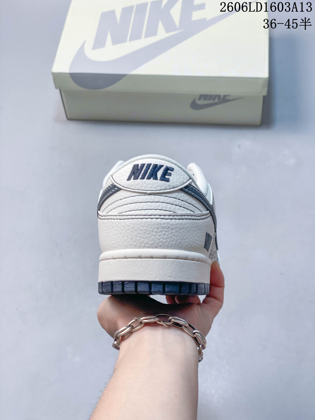 Rear view showing the heel branding and navy outsole.