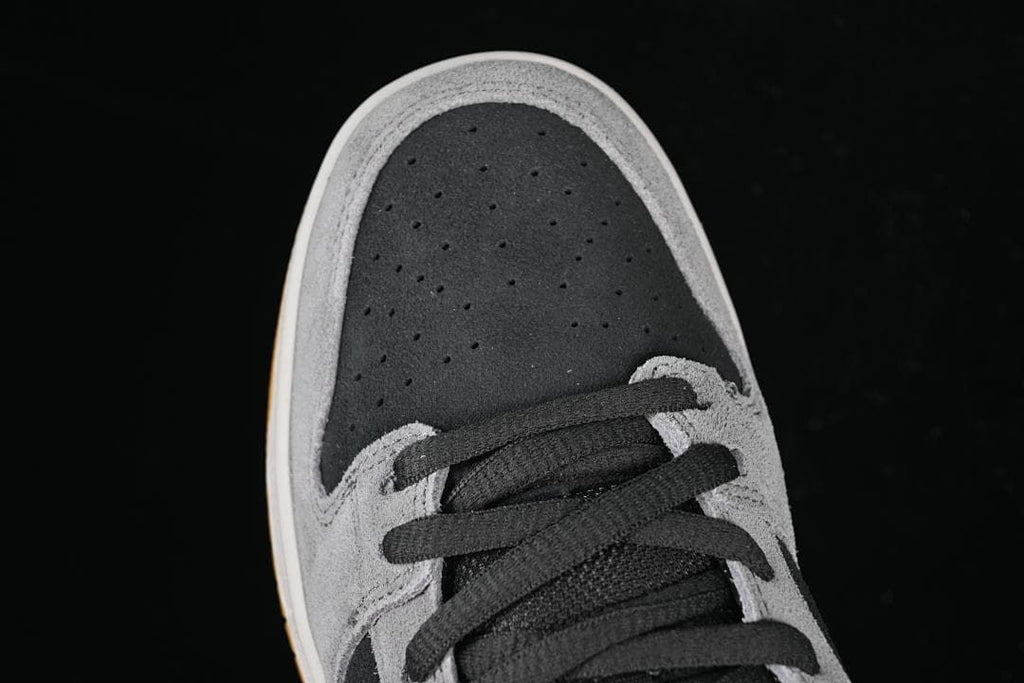 Top view of the perforated dark toe panel and black laces