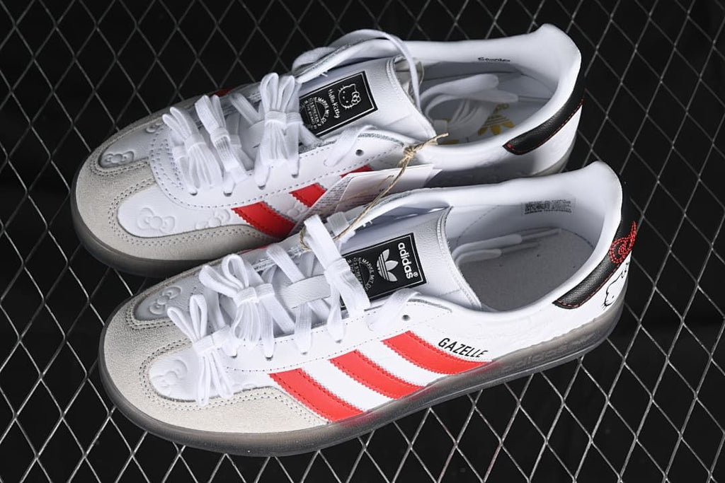 Pair of white and red Hello Kitty Gazelle Indoor sneakers shown from above at an angle.
