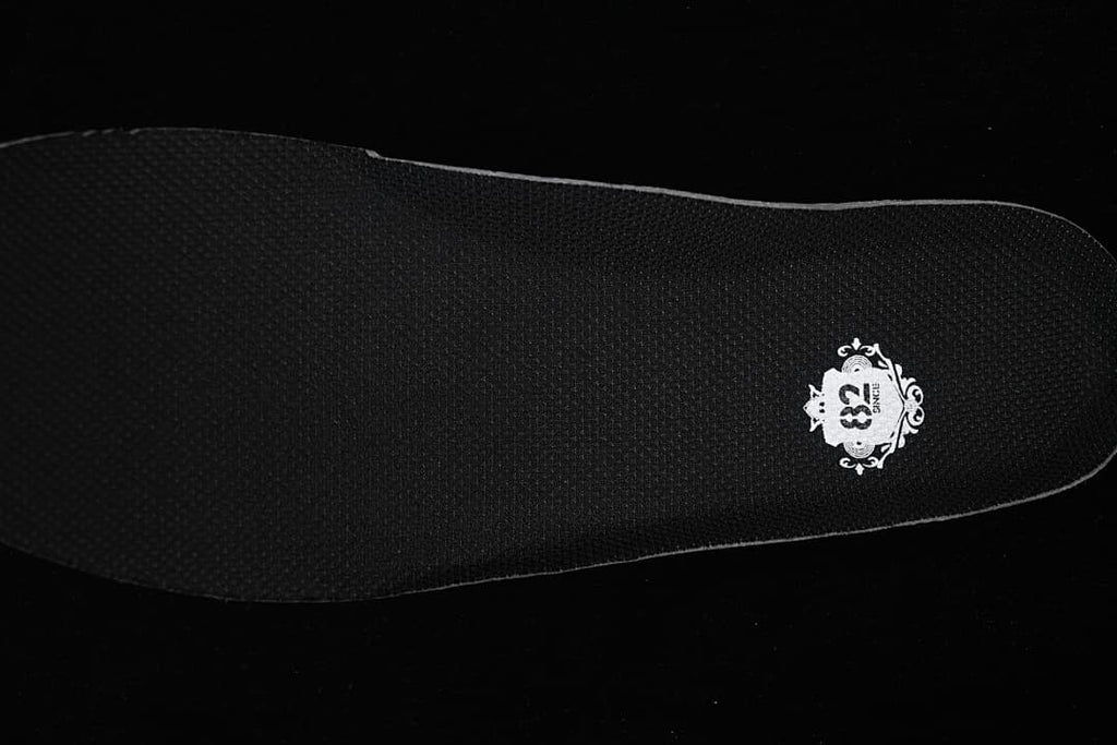 Black insole with a small white decorative graphic