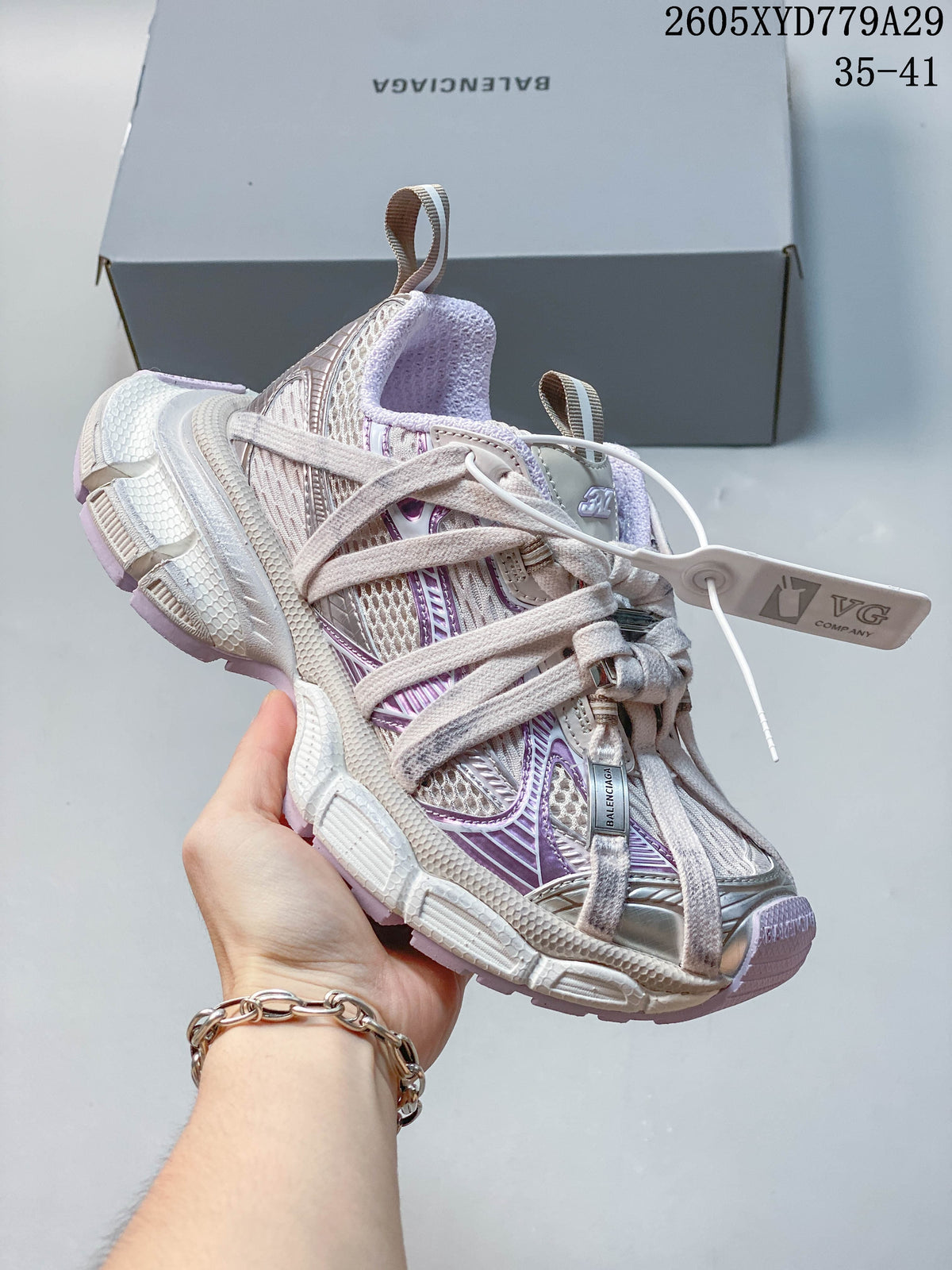 Angled side view of the silver and lavender sneaker