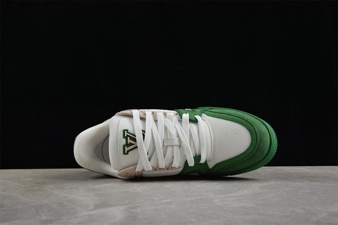 Top view of the white laces, tongue, and green trim