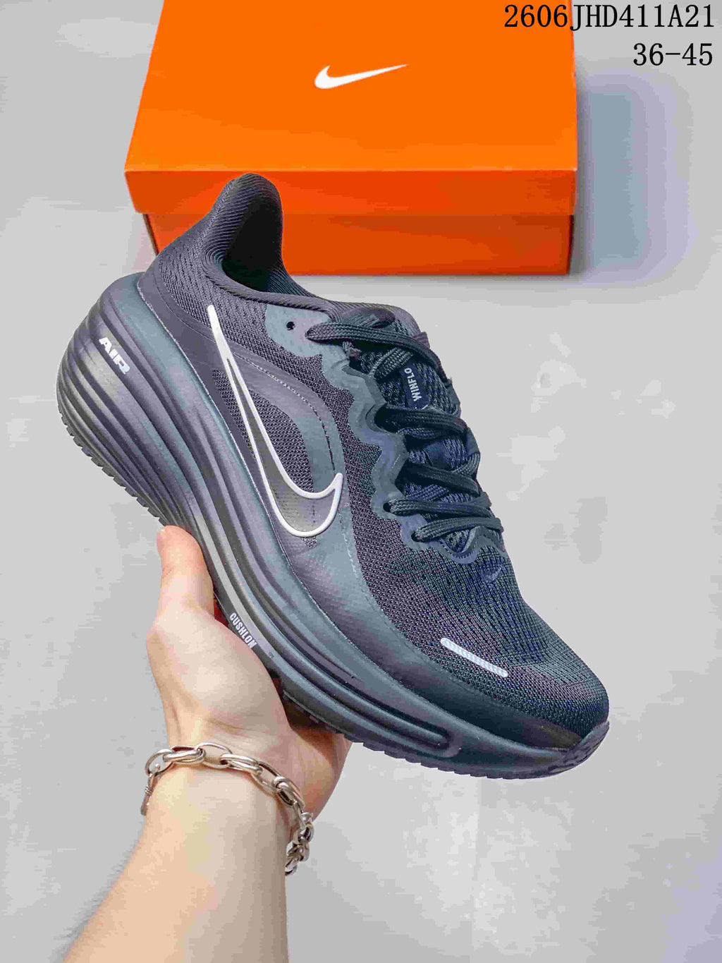 Dark grey Nike Air Zoom Winflo 12 running shoe with a light-coloured side logo