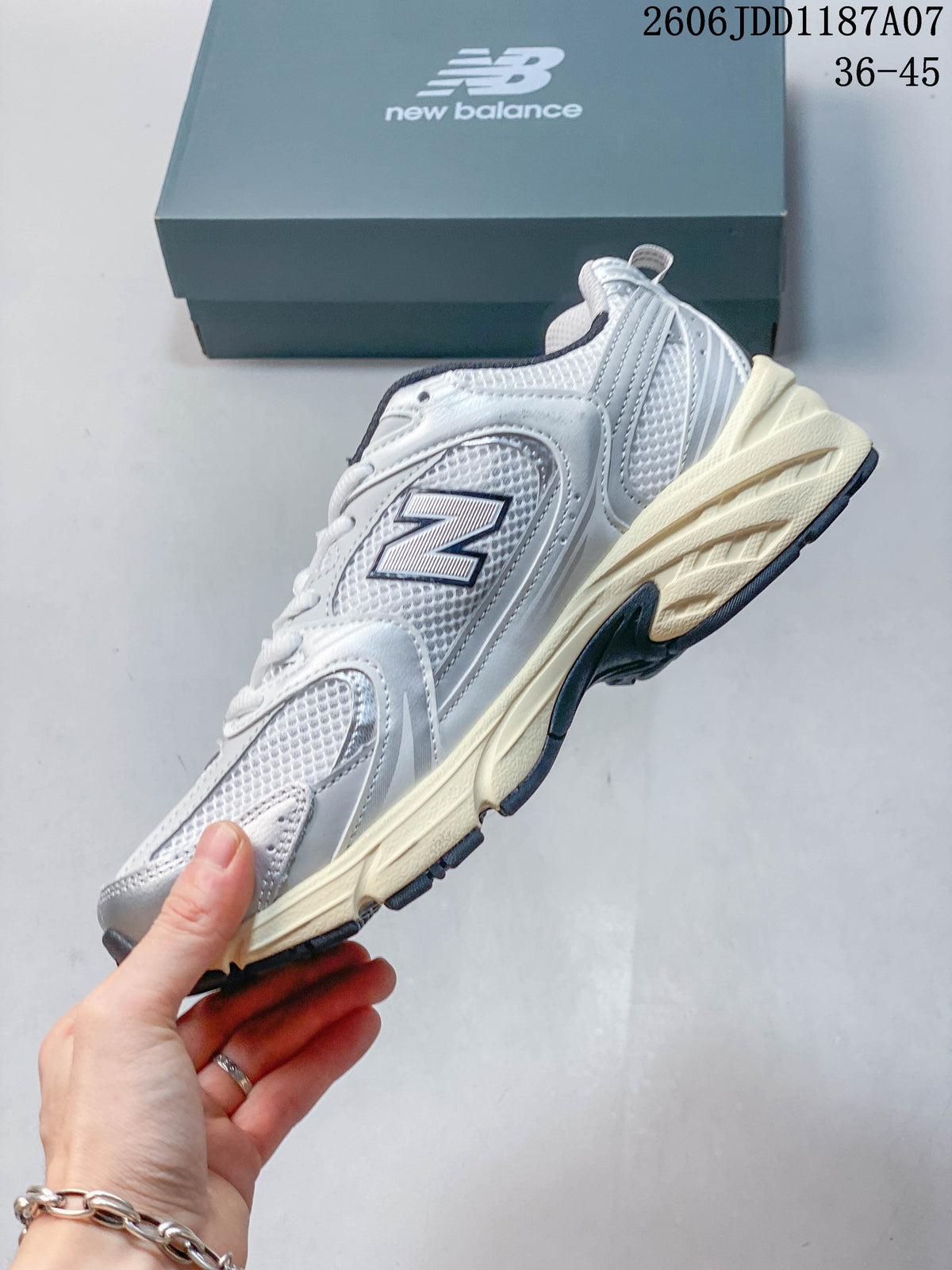 Side view showing the layered mesh-look upper and sculpted sole of a New Balance 530 sneaker