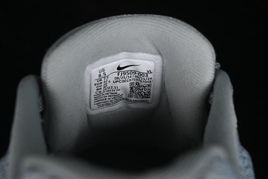 Close-up of shoe tongue label showing size information and style code FJ9509-003