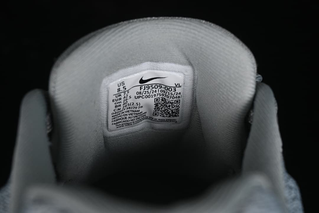 Close-up of shoe tongue label showing size information and style code FJ9509-003