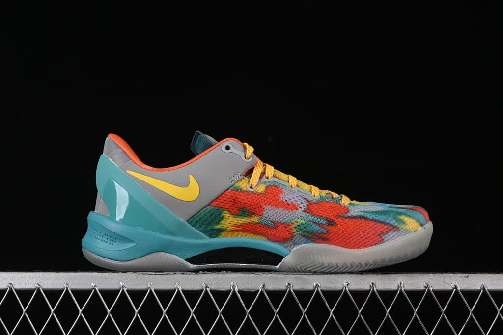 Side profile showing the multicolor upper, gray heel panel, yellow swoosh, and turquoise sole