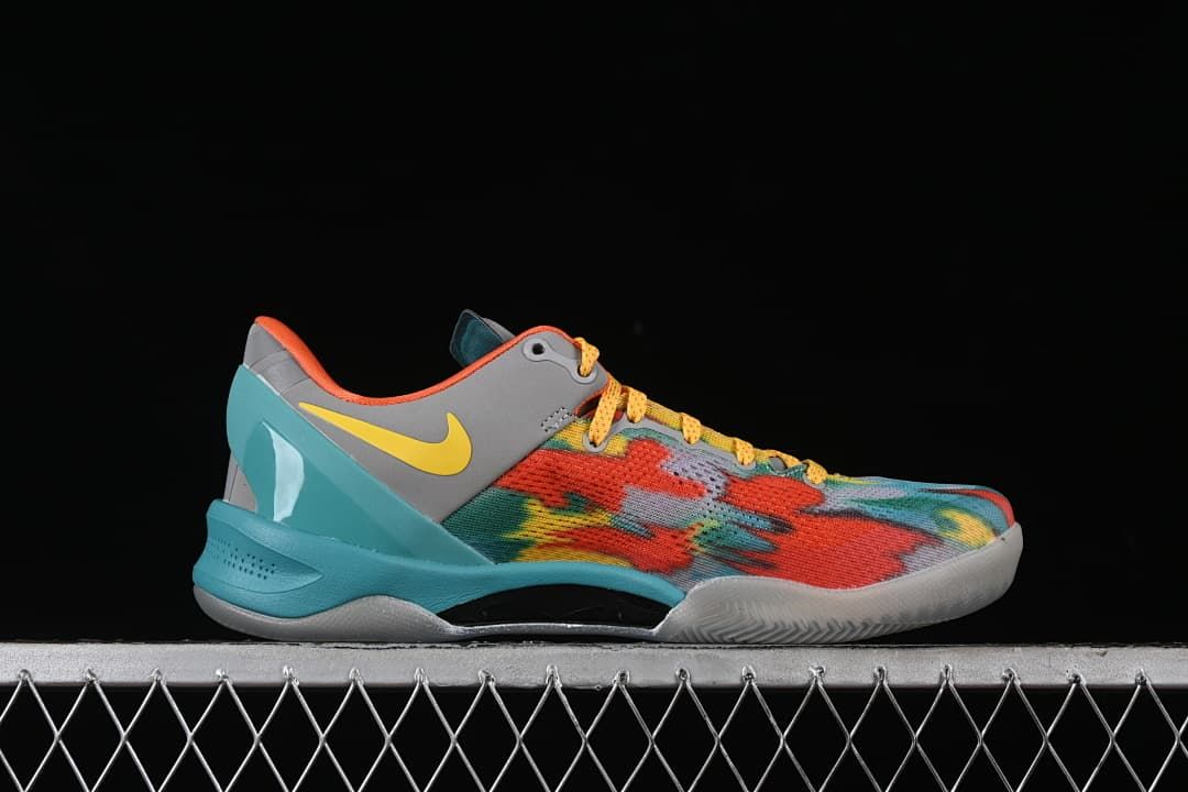 Side profile showing the multicolor upper, gray heel panel, yellow swoosh, and turquoise sole