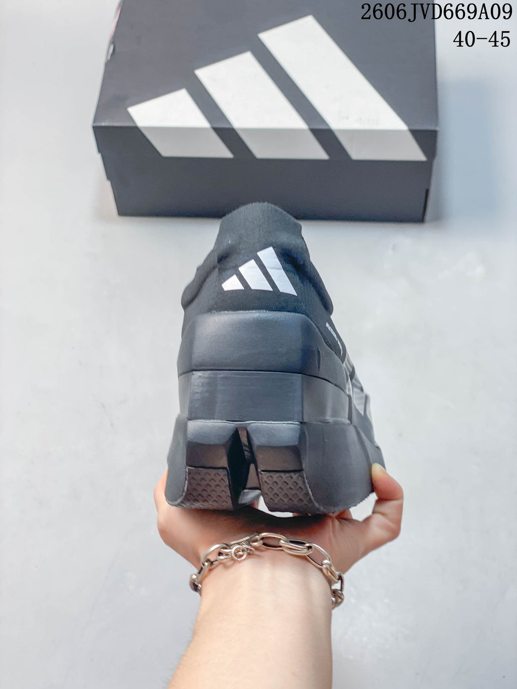 Rear view showing the heel and outsole of a dark gray Adidas shoe