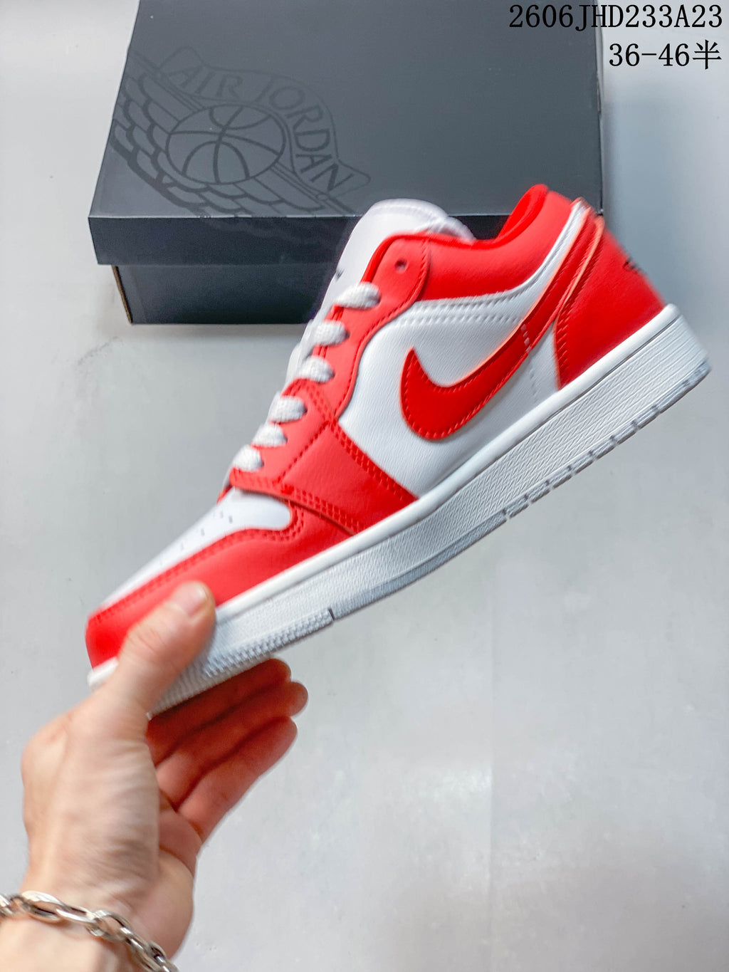 Side view of a red and white low-top sneaker