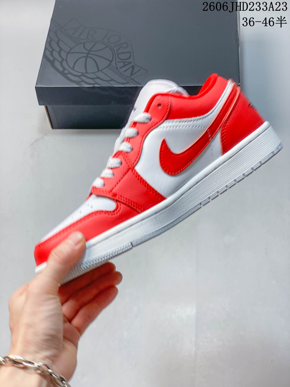 Side view of a red and white low-top sneaker
