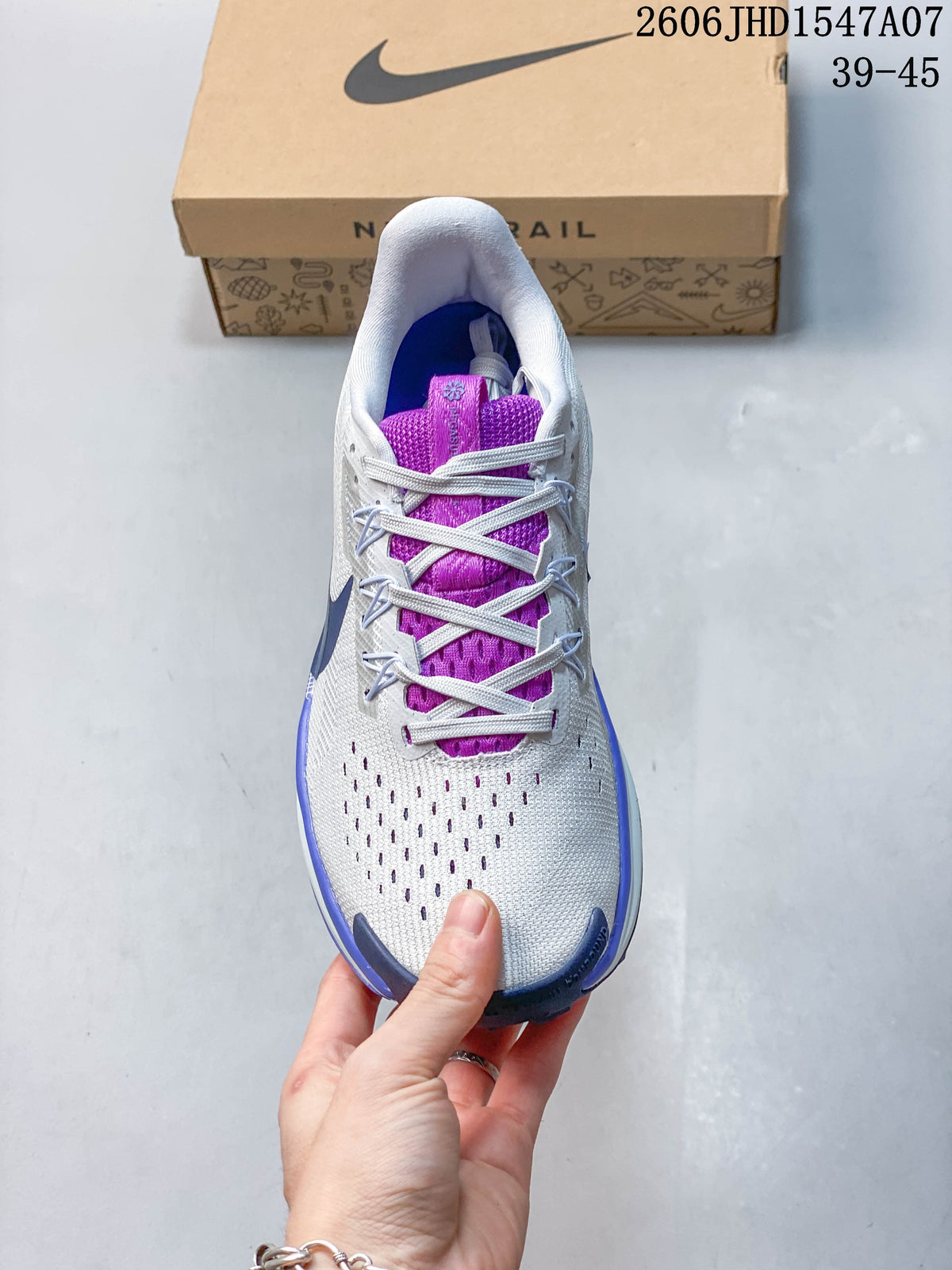Top view of a Nike ReactX Pegasus Trail 5 shoe showing its laces, perforated forefoot, and purple tongue.