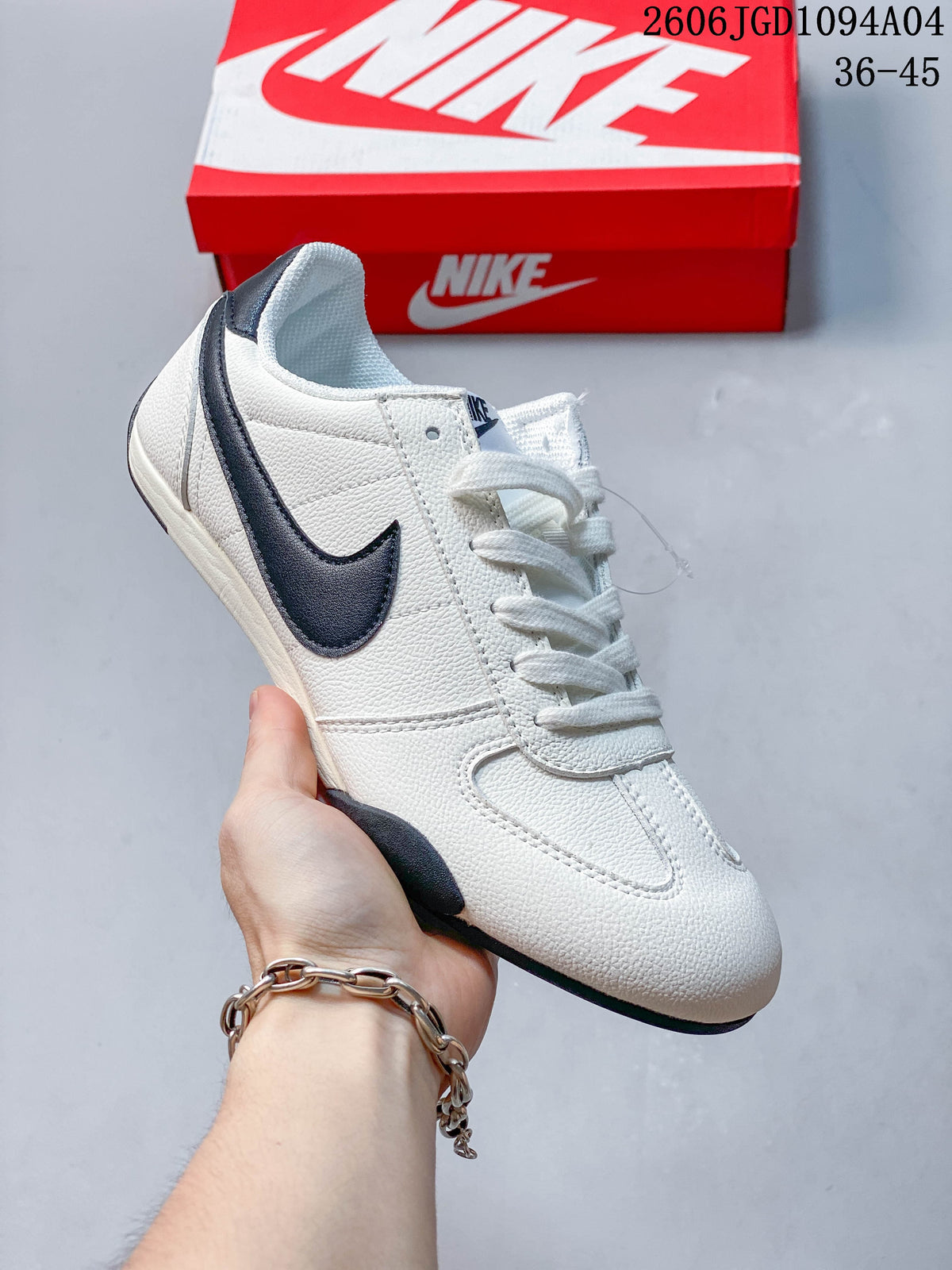 Angled side view of a white sneaker with a dark Swoosh and heel details