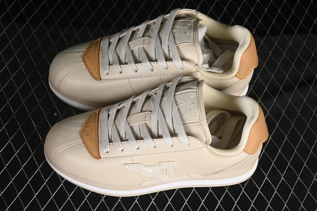 Pair of beige lace-up sneakers viewed from above