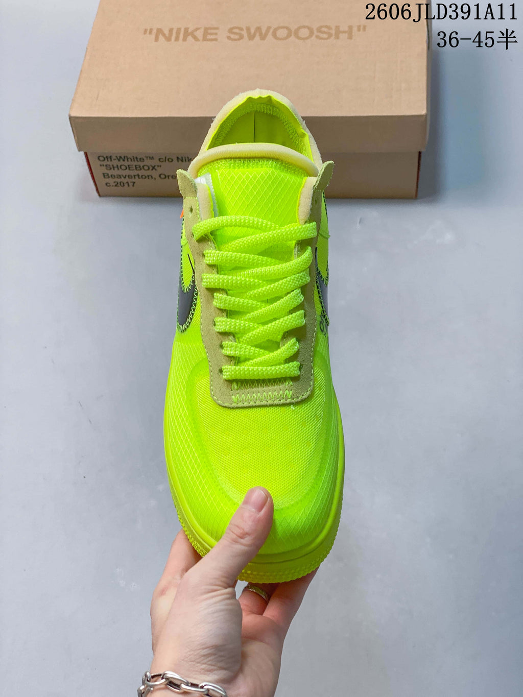 Front view of a volt-green lace-up sneaker with contrasting eyestays