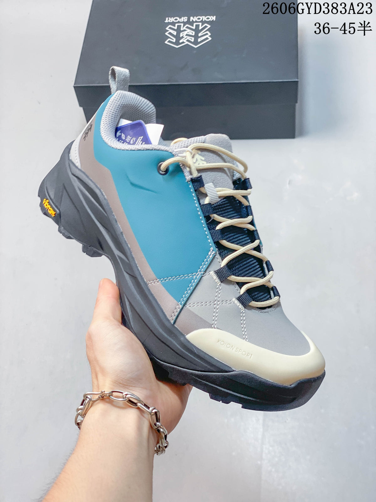 Angled side view of the shoe with turquoise panels and lugged sole