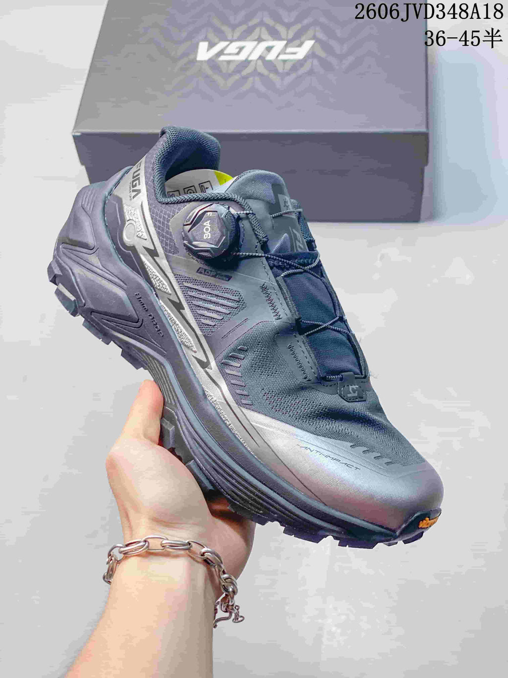 Angled view of a gray trail-running shoe with dial closure