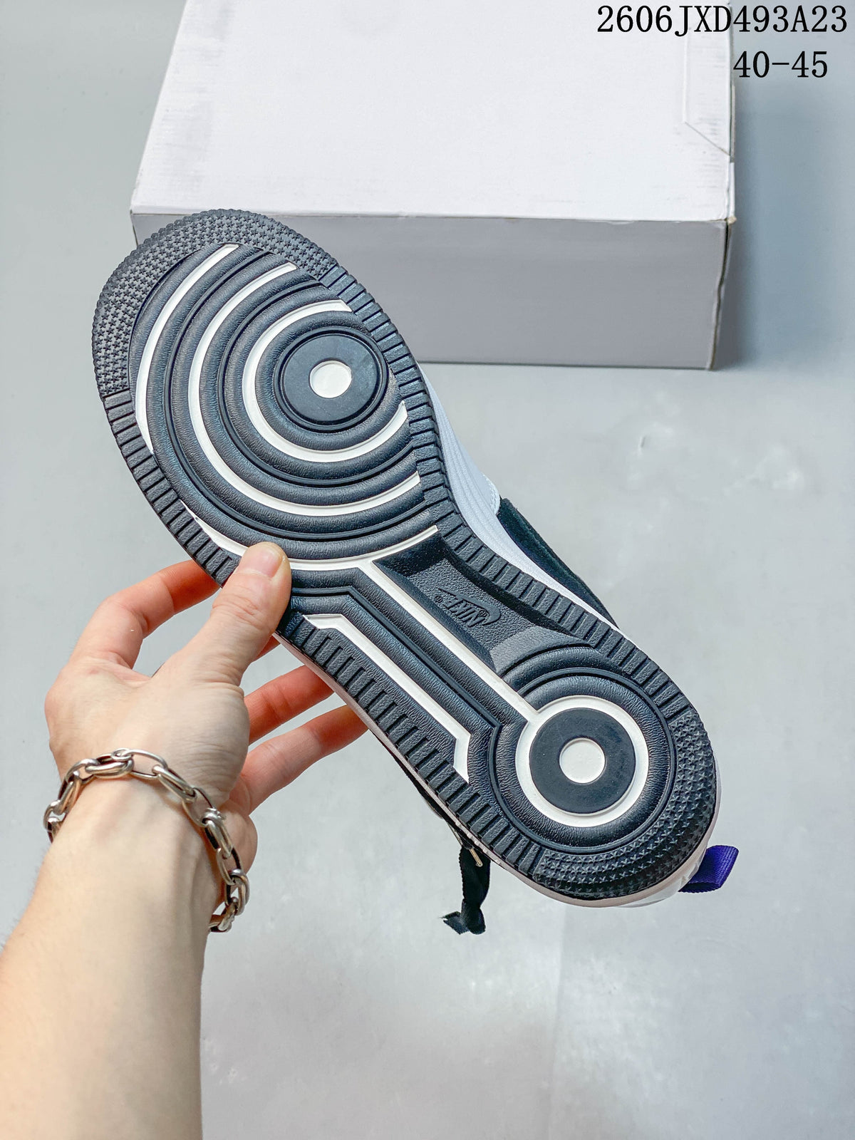 Underside of the sneaker showing its patterned outsole and circular traction details