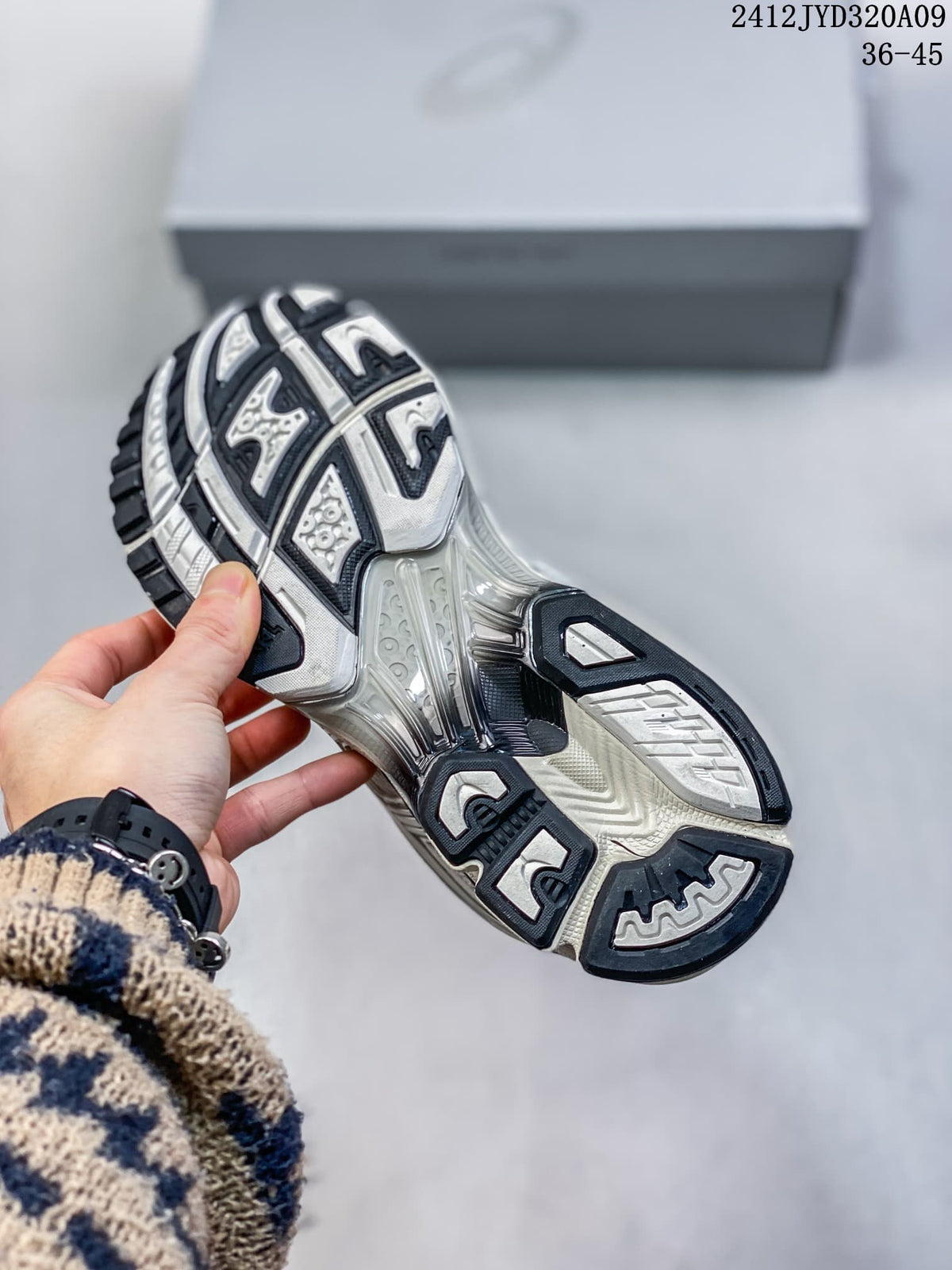 Close-up of the patterned black, gray, and light-colored outsole.