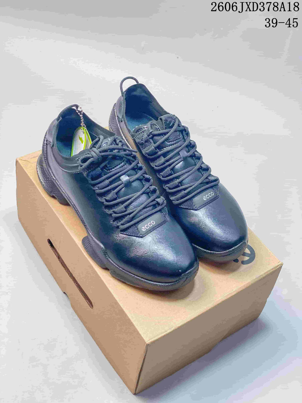 Pair of black ECCO BIOM lace-up sneakers displayed on a box