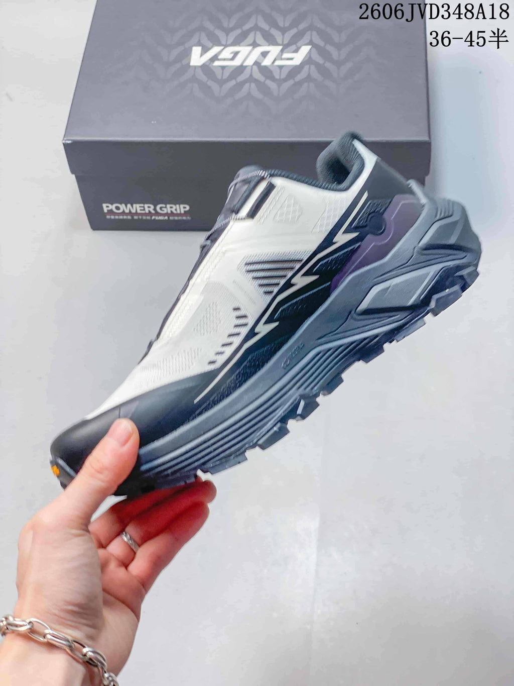 Side view of a light-colored Kailas FUGA EX3 trail shoe with dark accents and a rugged sole.