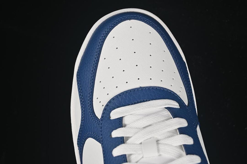 Top-down detail of the perforated white toe panel and navy overlays