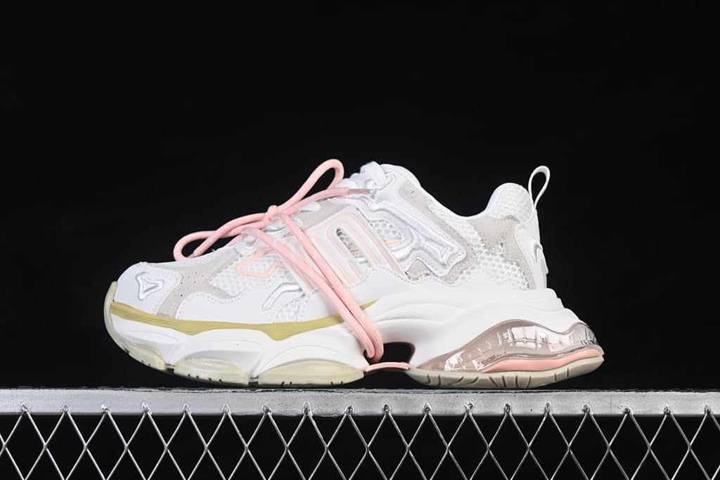 Side profile of the white and light-gray GG-CC sneakers with pink laces and pale yellow sole accents.