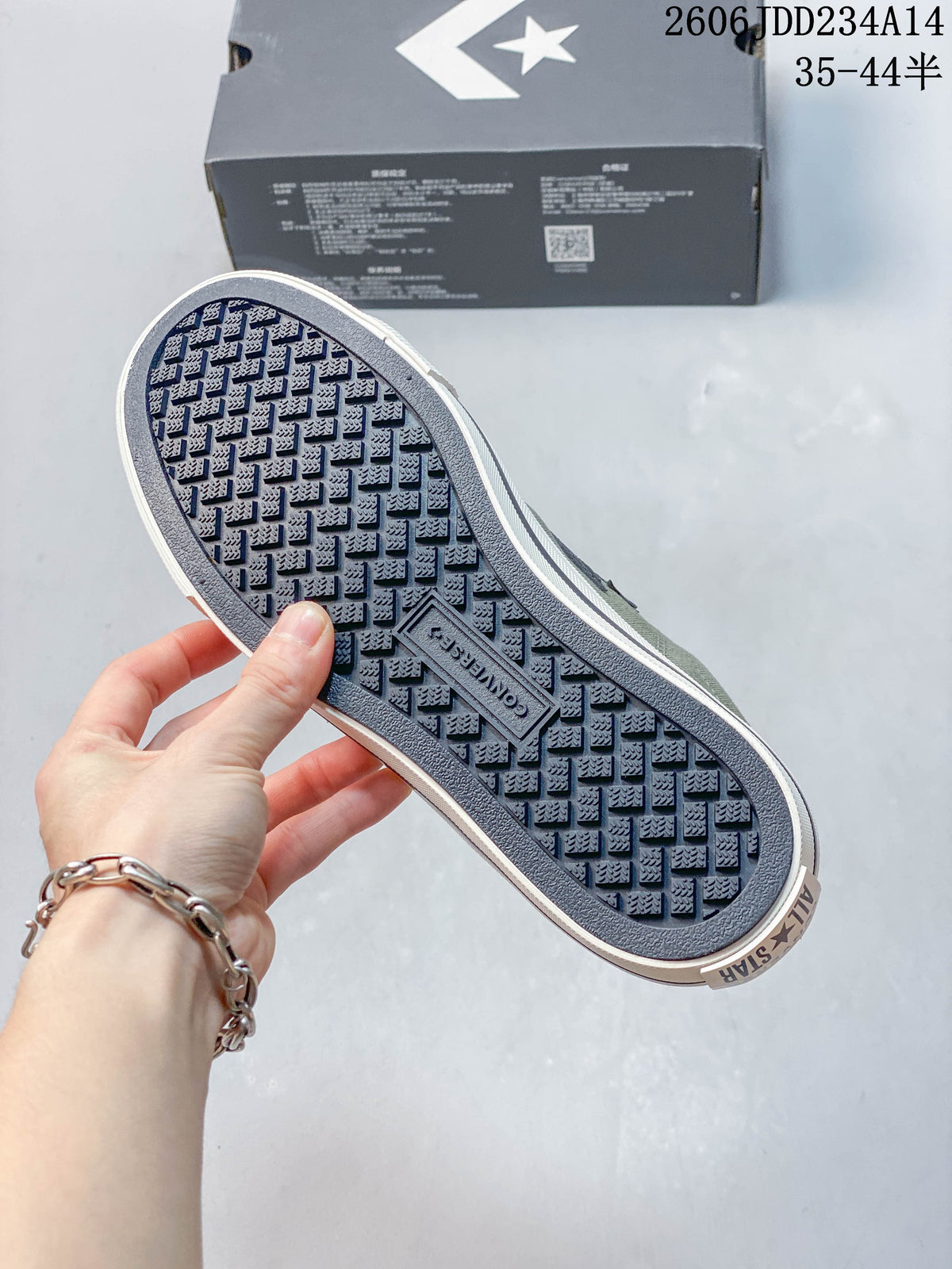 Close-up of the patterned outsole on the olive Converse sneakers