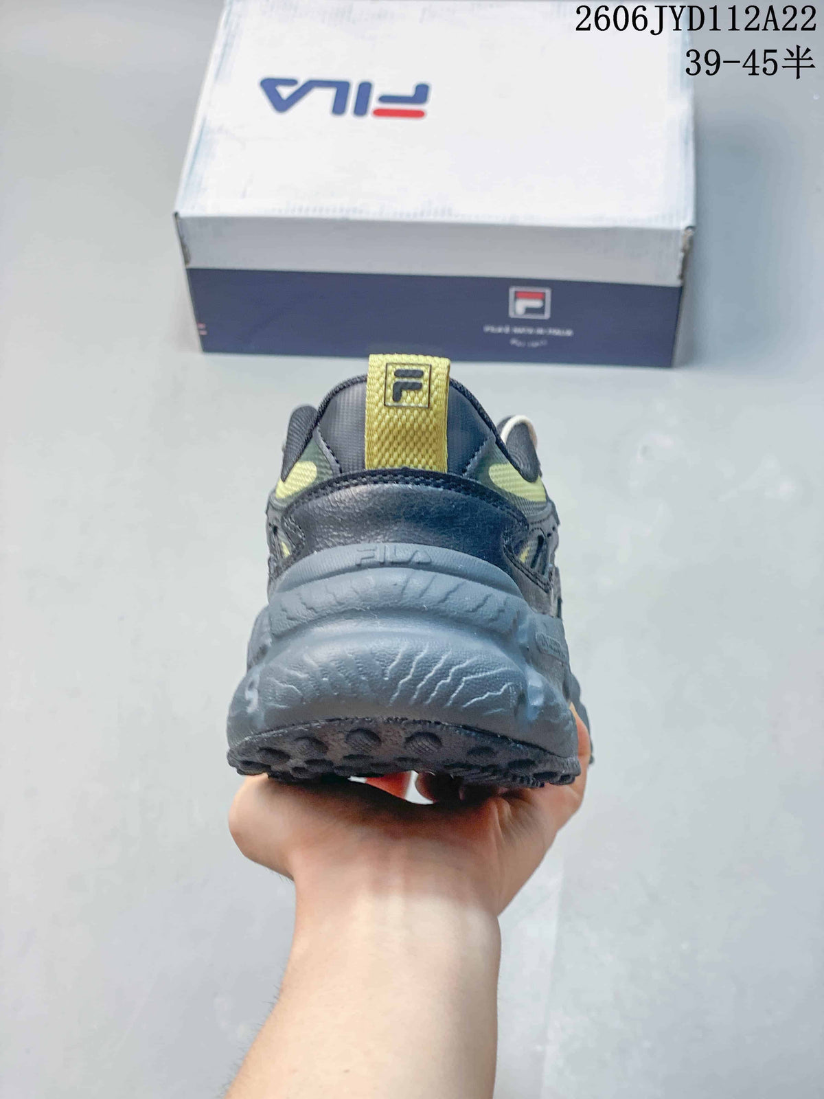 Rear view showing the sculpted sole and heel details of a FILA sneaker