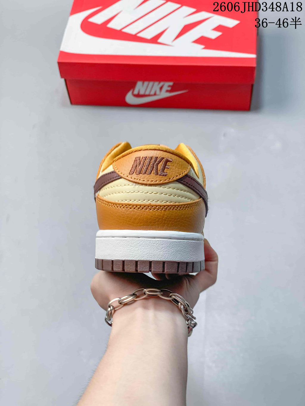 Rear view showing the cream and brown heel panels of the low-top sneaker